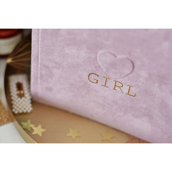 Pink suede baby milestone photo album with "GIRL" in gold foil and an embossed heart.