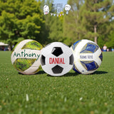 Three personalized size 5 footballs on grass: green with "Anthony," classic black and white with "Danial," and blue/white with "NAME HERE.