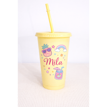 Yellow 24oz personalized tumbler with straw, featuring "Mila" and colorful pineapple, rainbow, and drink designs.
