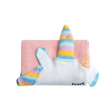 Pink knit blanket folded with a white unicorn head, colorful horn, and closed eyes.
