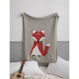 Cozy gray knit blanket with a charming red and white fox design, perfect for kids' rooms.