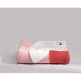 Folded pink, white, and red knit blanket with a cute animal face design.