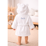 White organic cotton baby bathrobe with bear ears hood and "Jack" embroidered on the back.
