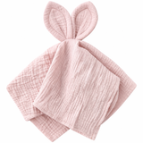 Soft pink cotton muslin baby comforter with bunny ears, folded.