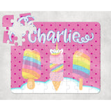 Personalized 60-piece kids puzzle with "Charlie" in white script, featuring two rainbow popsicles and a unicorn ice cream cone on a pink polka dot background.