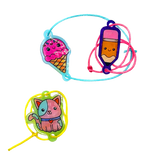 Two colorful shrink art bracelets: one with an ice cream and pencil charm, another with a cute cat charm.