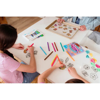Kids coloring Ooly Shrink Its! DIY shrink art charms like tacos and ice cream with colorful markers.
