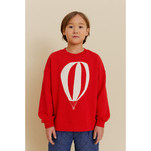 Kid's red organic cotton oversized sweatshirt with a white hot air balloon print.