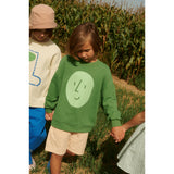 Green organic cotton kid's oversized sweatshirt with a light green potato face print.