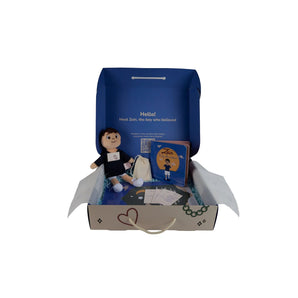 Box containing a plush toy and book with a QR code on a gray background