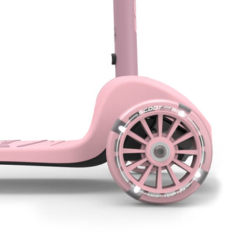 Close-up of a pink Scoot & Ride Highwaykick 3S LED kids scooter with a clear, light-up front wheel.