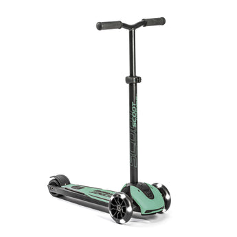 Black and mint green Scoot & Ride Highwaykick 5 LED kickboard scooter with glowing white wheels.