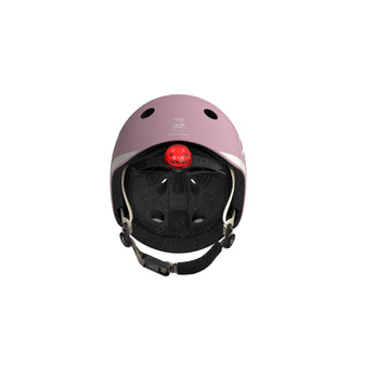Pink Scoot & Ride kids helmet with a red LED light, adjustable straps, and magnetic fastener.