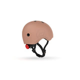 Scoot & Ride kids helmet in matte peach with a red rear light and black straps.
