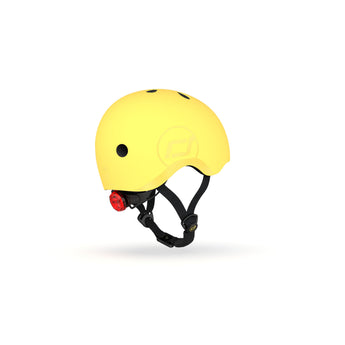 Bright yellow Scoot & Ride kids helmet with a red rear light and black straps.