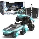 Two Sharper Image Stunt Mongoose RC cars, one mid-stunt with glowing blue LEDs, beside its box and controller.
