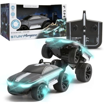 Two Sharper Image Stunt Mongoose RC cars, one mid-stunt with glowing blue LEDs, beside its box and controller.