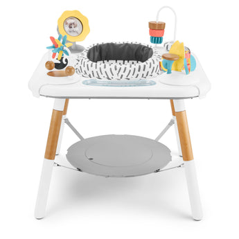 White Skip Hop Discoverosity 3 Stage Activity Center with colorful toys, wooden legs, and gray seat.