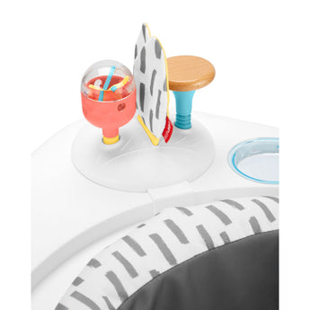 Skip Hop Discoverosity 3 Stage Activity Center with colorful toys, a wooden seat, and gray patterned fabric.