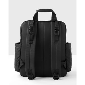 Black quilted Skip Hop Forma backpack nappy bag, showing back straps and side pockets.