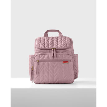 Pink quilted Skip Hop Forma nappy bag backpack with gold zippers and side pockets.