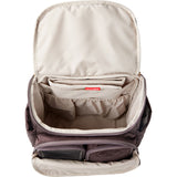 Open Skip Hop Forma quilted backpack in dark purple, showing spacious beige interior with multiple pockets.