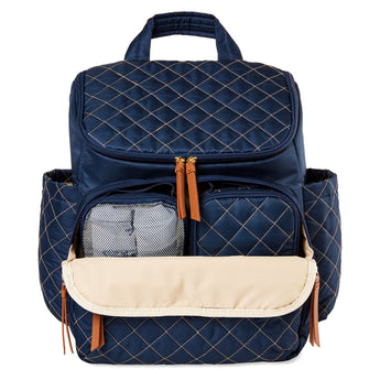 Navy quilted Skip Hop Forma backpack nappy bag with open front pocket, brown zipper pulls, and side pockets.