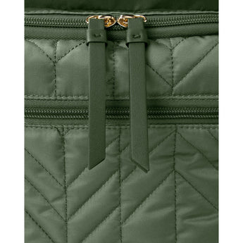 Close-up of a dark green quilted Skip Hop Forma backpack with gold zippers and leather pulls.