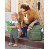 Skip Hop Forma quilted olive green nappy bag next to a dad and toddler.