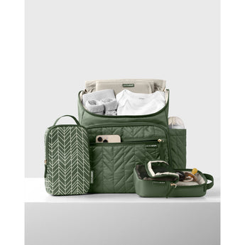 Olive green quilted Skip Hop Forma backpack with packing cubes, baby clothes, and bottle.