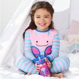 Smiling child in pink pajamas holding a Skip Hop stainless steel straw water bottle with a pink butterfly design.