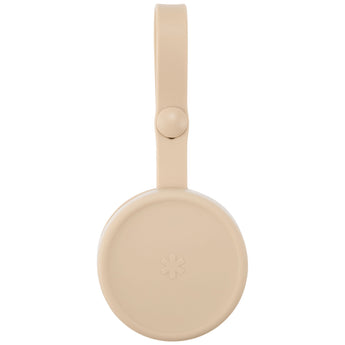 Skip Hop beige silicone pacifier holder with a top strap and small star logo.