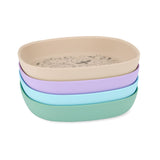 Stack of four Skip Hop Squad silicone kids plates in beige, lavender, blue, and green with etched animal designs.