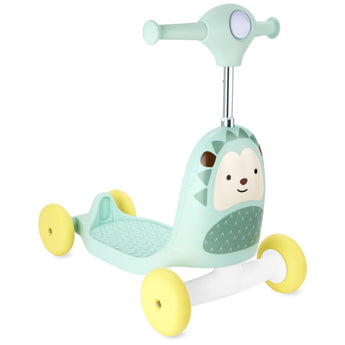 Mint green Skip Hop Zoo 3-in-1 hedgehog ride-on toy with yellow wheels and a white base.