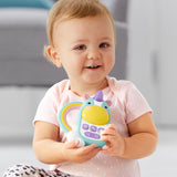 Smiling baby holds a light blue Skip Hop Zoo Phone unicorn toy with a purple horn and rainbow handle.