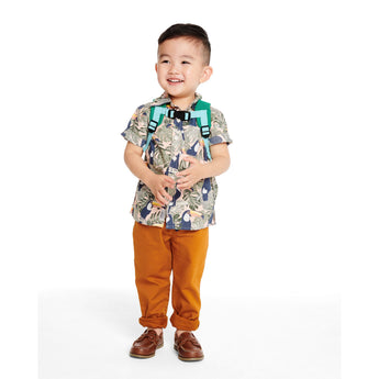 Smiling toddler boy wearing a green Skip Hop Zoolet Bee mini backpack with a detachable tether.