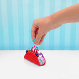 Hand sprinkling colorful sprinkles onto a red slime taco with purple and white slime fillings.
