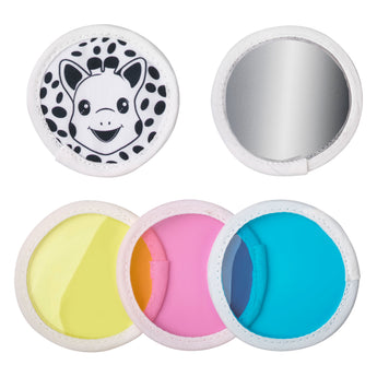 Sophie la girafe Magic Mirror SIGHT Teething Toy with white fabric trim, featuring a giraffe face, mirror, and yellow, pink, and blue colored lenses.