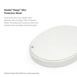 White oval Stokke Sleepi Mini Protection Sheet, waterproof and textured, protecting a mattress.