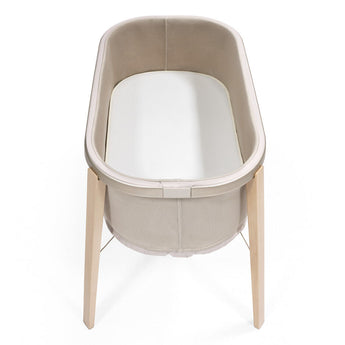 Stokke Snoozi Protection Sheet shown in bassinet