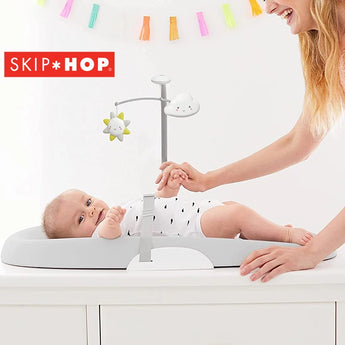 Skip Hop Nursery Style Wipe-Clean Changing Pad lifestyle with baby